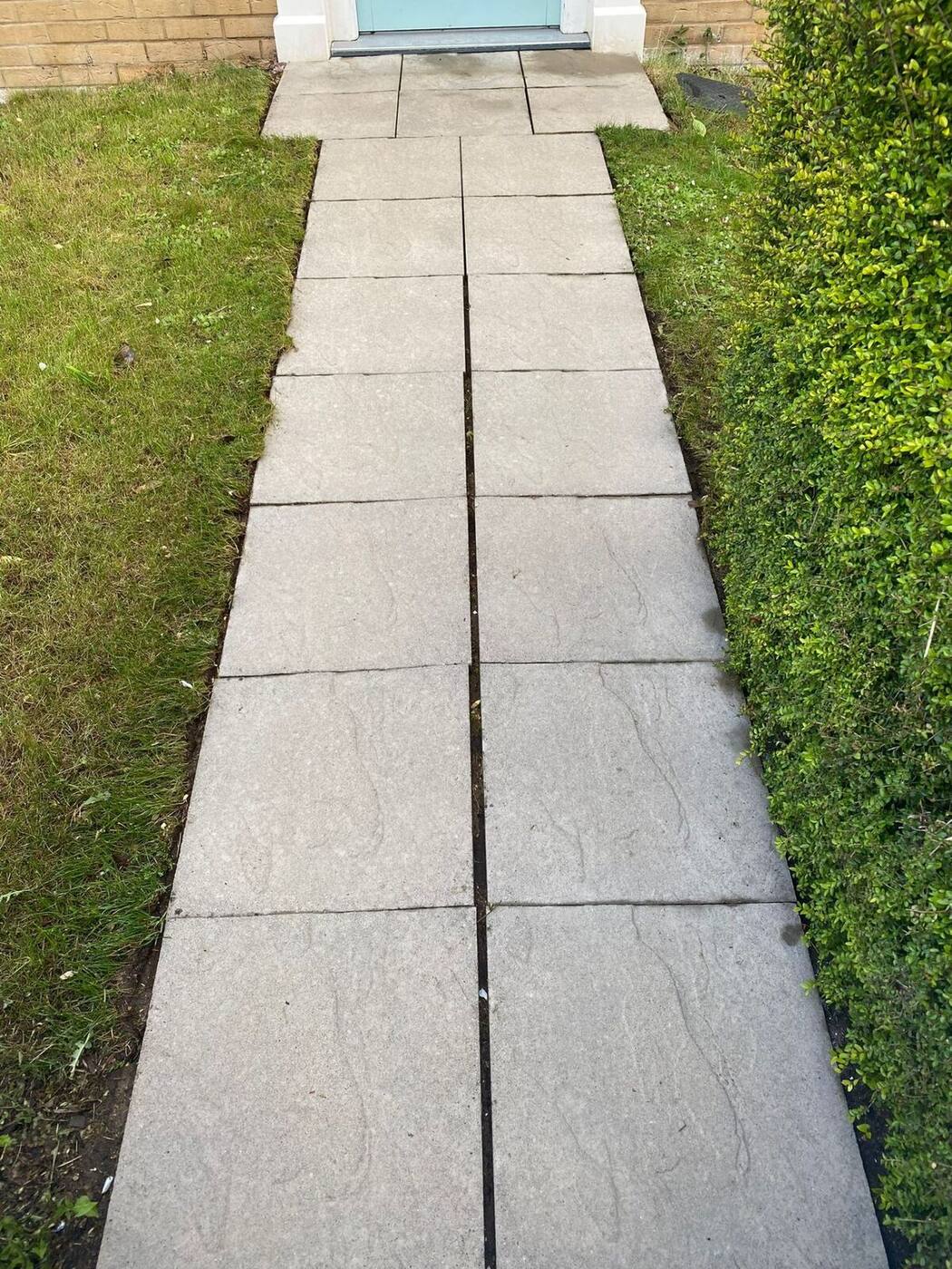 Restored garden path showing clean surface after pressure washing