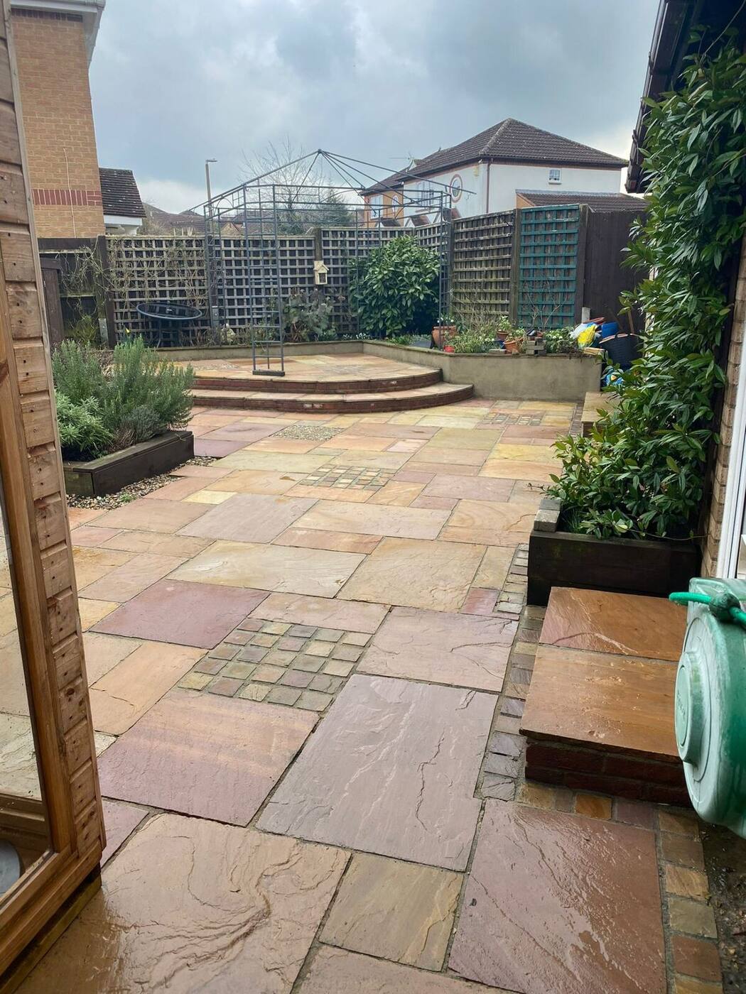 Restored natural stone patio slabs showing warm colour after professional pressure washing